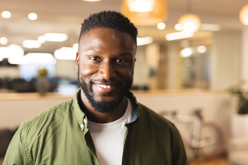 Portrait of smiling african american male creative looking to camera