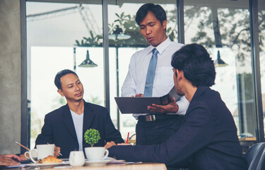 Group of business people meeting in conference room brainstorming consult business document graph chart office desk. Diversity multiethnic group of business people brainstorming and working together.