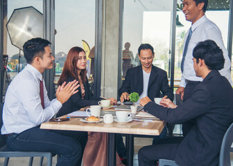 Fototapeta premium Group of business people meeting in conference room brainstorming consult business document graph chart office desk. Diversity multiethnic group of business people brainstorming and working together.