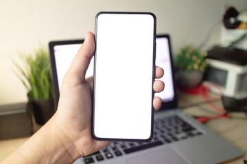 Man's hands holding or using smartphone with two hands. Smartphone with white blank on screen, Cellphone mockup.