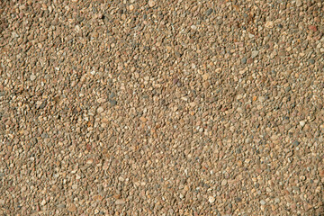 Small stone pebble surface background texture. Top view.