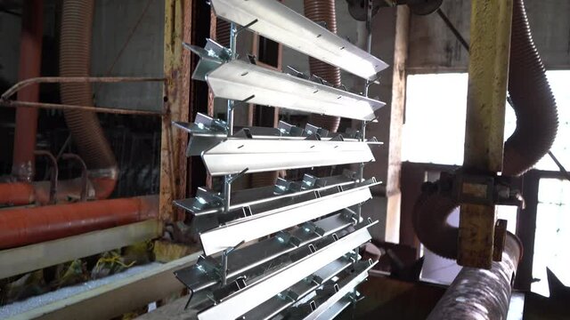 Metal parts lifted into industrial bath. Galvanization process