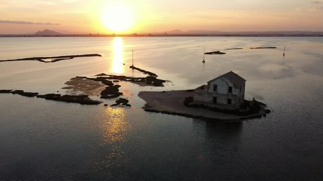 House isolated by water in mediterranean sea drone view. Lonely house in island surrounded by water as a consecuence of sea level growth due to melt down of polar ice, defrostation. 