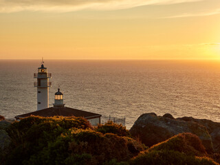 Tourinan Lighthouse in Muxia, Galician coast, Spain. Twice a year, at the beginning of spring and the end of summer, Cape Touriñan becomes the last shadow for the sunset in continental Europe.