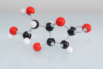 Isolated vitamin C made by molecular model with reflection on white background. Ascorbic acid...