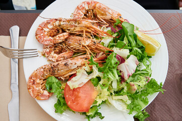 Dish of green salad with prawns