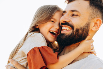 Portrait of daughter with father who are happily smiling and embracing