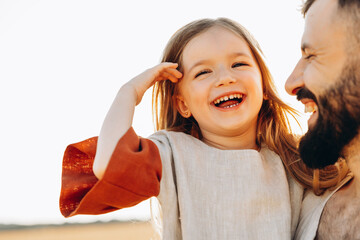 Portrait of daughter with father who are happily smiling and embracing