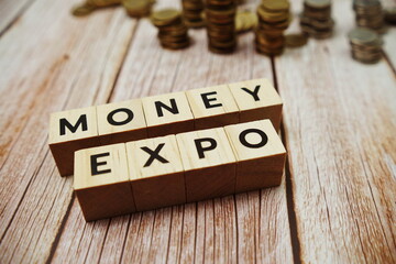 Monney Expo alphabet letter and coins on wooden background