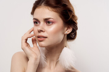 woman with bare shoulders fluffy earrings fashion close up