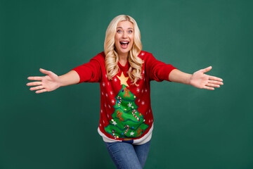 Photo of amazed shocked young happy woman open hands you good mood xmas isolated on green color background
