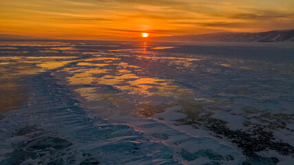 Magnificent sunset over frozen Lake Baikal. &nbsp;Frozen pieces of ice on the lake surface. Irkutsk region, Russia