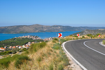 Croatian landscape with mountains, sea, town in the valley and road