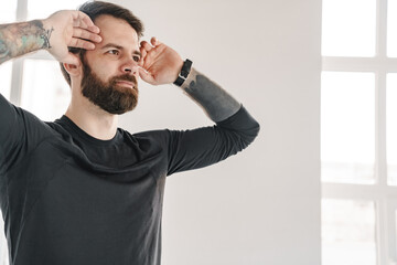 Calm mid aged bearded man in sportswear