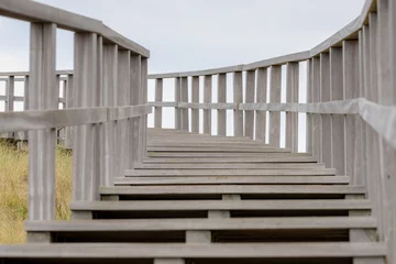 Photo sur Plexiglas Mer du Nord, Pays-Bas Structure and curve of wooden stairs and rails with selective focus, Outdoor wood ladder to the viewpoint, Petten is a town in the Dutch province of North Holland, Municipality of Schagen, Netherlands