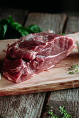 Raw pork piece on wooden board