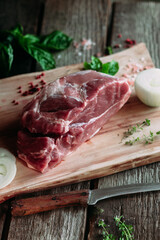 Raw pork piece on wooden board