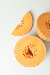Ripe melon slices on white background, top view