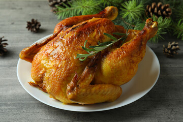 Concept of Christmas roast turkey on gray textured table