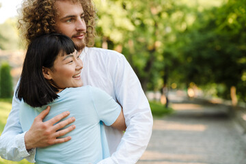 Happy young multiethnic couple in park