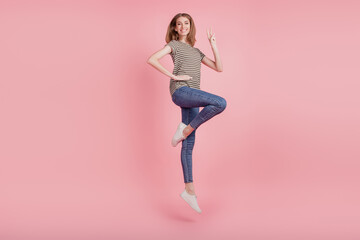 Full length profile side photo of young woman happy positive smile show peace cool v-sign jump up...