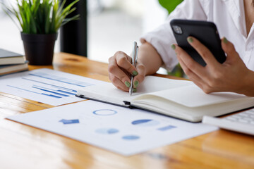Close up of Business woman accountant or financial expert analyze business report graph and finance chart at corporate office. Concept of finance economy, banking business and stock market research. 