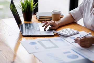 Close up of Business woman accountant or financial expert analyze business report graph and finance chart at corporate office. Concept of finance economy, banking business and stock market research. 