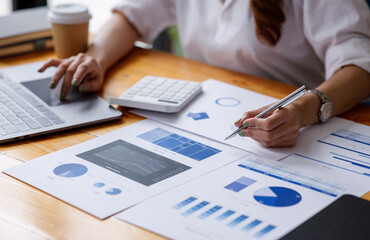 Close up of Business woman accountant or financial expert analyze business report graph and finance...