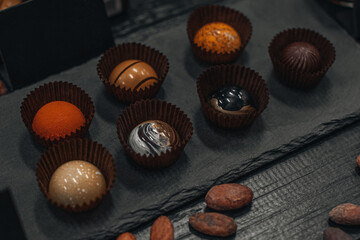 Exclusive handmade chocolate candy. Product concept for chocolatier. Dark milk chocolates set...