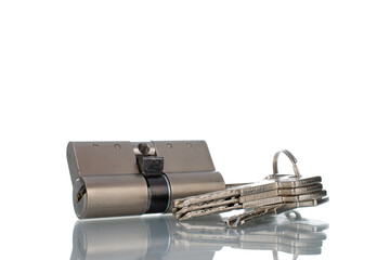 One lock core with keys, close-up isolated on white.