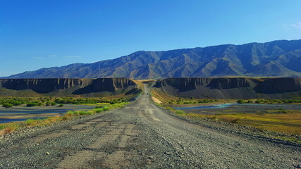 Road between rocks and mountains