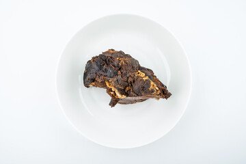 Piece of beef with sauce on white background