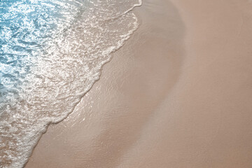 Sea waves rolling onto sandy tropical beach