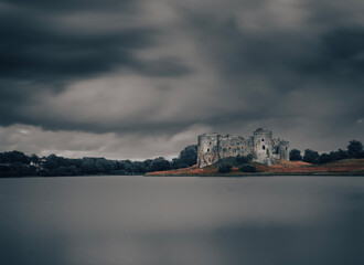 clouds over castle and lake