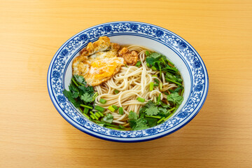 A bowl of egg noodles on the table