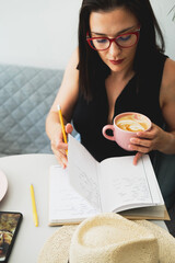 Young beautiful woman at a table in a cafe talking on the phone. 