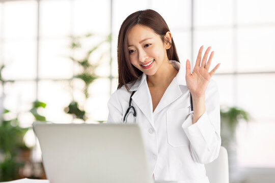 Doctor Watching Laptop Computer And Having Video Conference At Clinic.