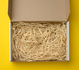 rectangular open corrugated paper box with sawdust inside. Packaging, containers for transportation...