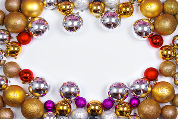 Gold, red and silver glitter Christmas balls pattern. Flat lay, top view, copy space. Christmas golden, red and silver balls decorations on white background. New year creative arrangement frame.