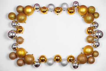 Gold and silver glitter Christmas balls pattern. Flat lay, top view, copy space. Christmas golden and silver balls decorations on white background. New year creative arrangement frame.