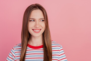 Fototapeta premium Photo of curious smart cheerful lady beaming white smile look side empty space on pink background