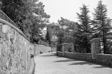 a beautiful street of the old city, a wall paved with light stone, a road, a sidewalk, everything for people's life