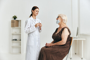 an elderly woman at a doctor's appointment an injection into the arm immunity protection