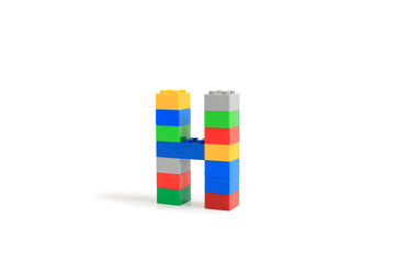 Alphabet letters H from colorful plastic brick block constructor isolated on white background. Image with Clipping path