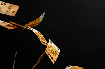 Rain with euros, European currency on a black background, winning the lottery.
