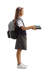 Full length profile shot of a schoolgirl giving books and smiling