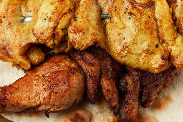 Fried chicken meat with a golden crust on skewers. Appetizing dish. Close-up.