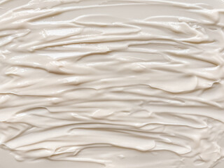 Cream texture for the background in beige colors.  Cream strokes.  Natural cosmetics for face and body.  Flat lay, top view, copy space.