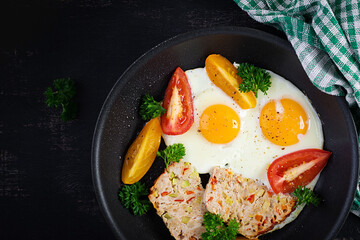 Plate with a keto diet food. Fried egg, meatloaf, and tomatoes. Keto, paleo breakfast. Top view, flat lay