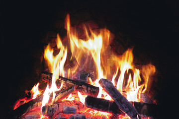Fire from firewood. Hearth. It's dark all around.
